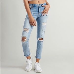 Ripped garage light wash girlfriend jeans.